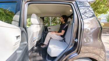 Nissan Sakura - rear interior being sat in by Auto Express senior staff writer Jordan Katsianis 